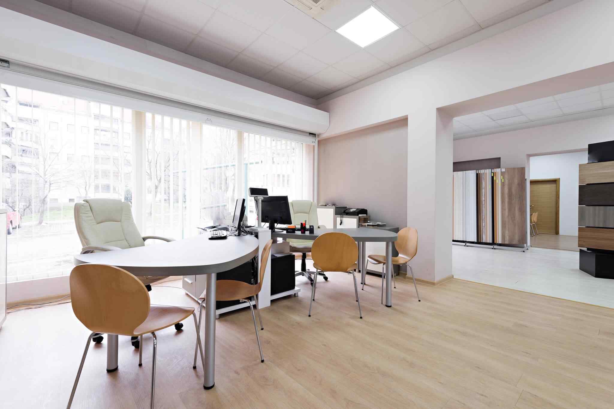 A room with several tables and chairs in it.