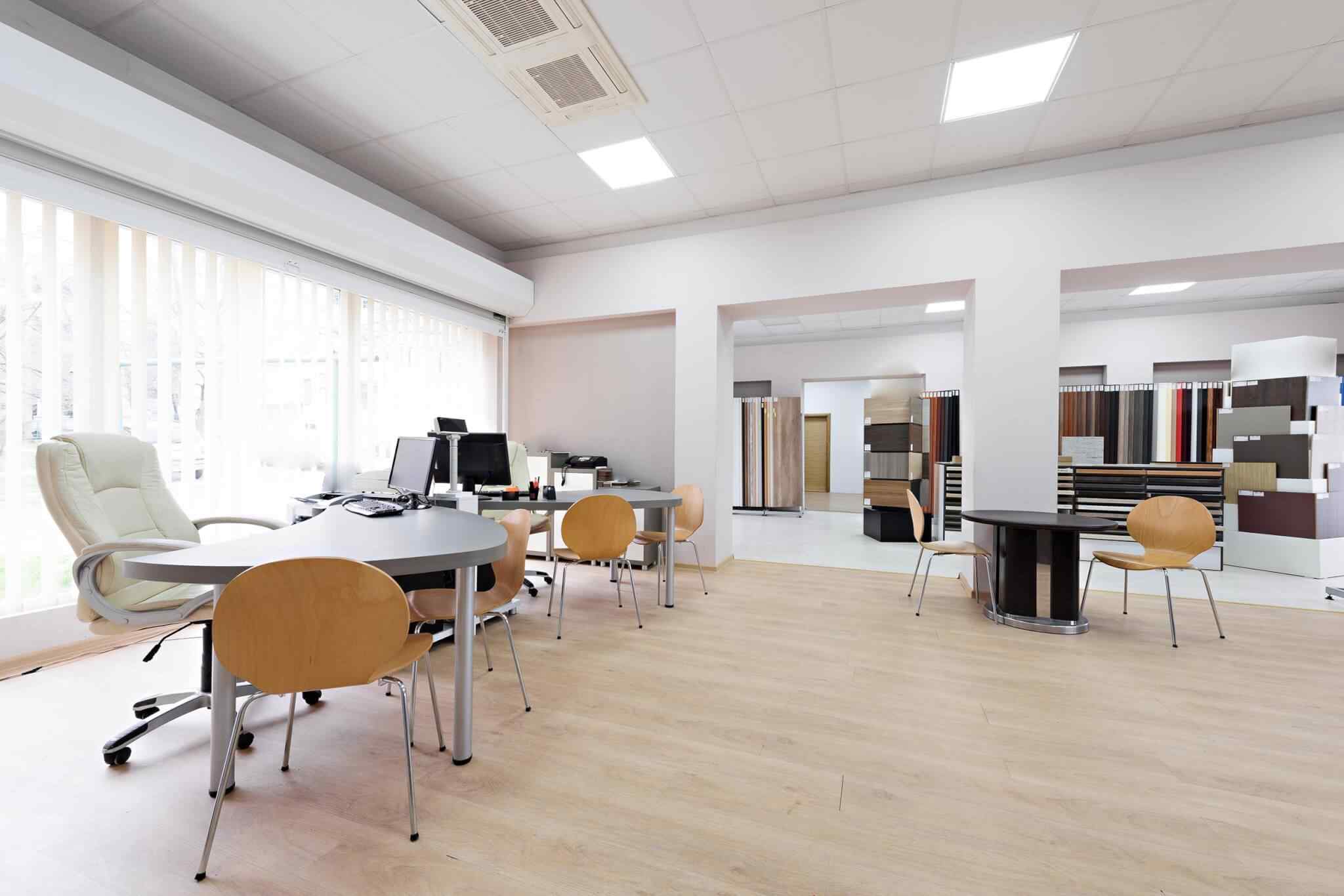 A room with many tables and chairs in it