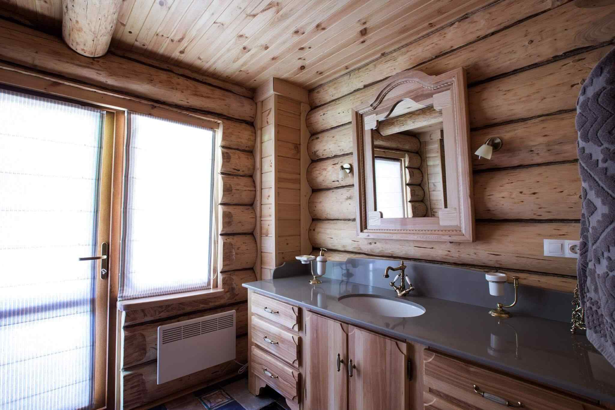 A bathroom with wood walls and floors.