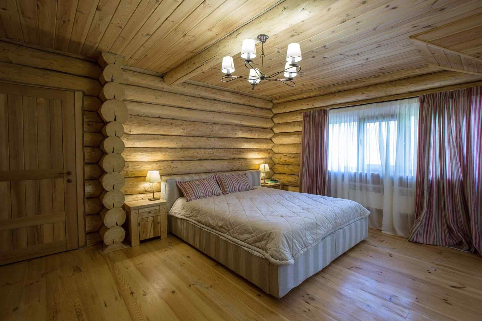 A bedroom with wood walls and floors.