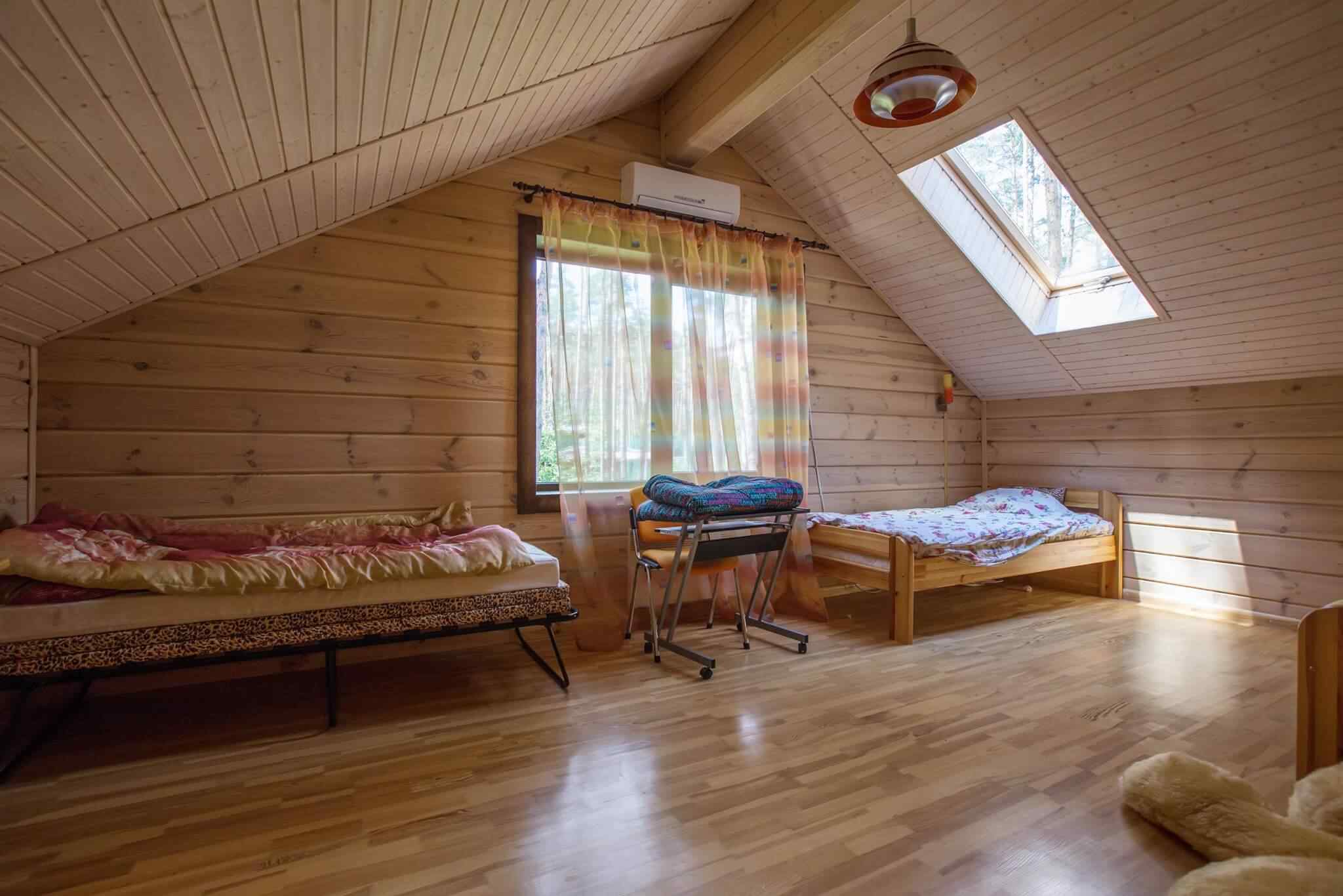 A room with two beds and a window.