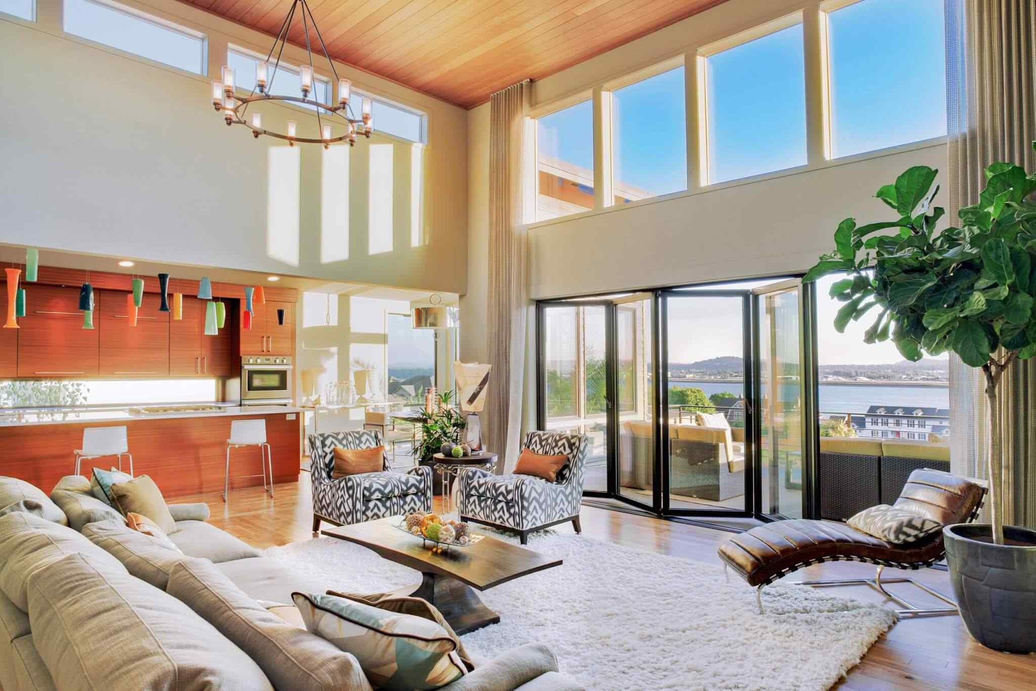 A living room with large windows and a view of the mountains.