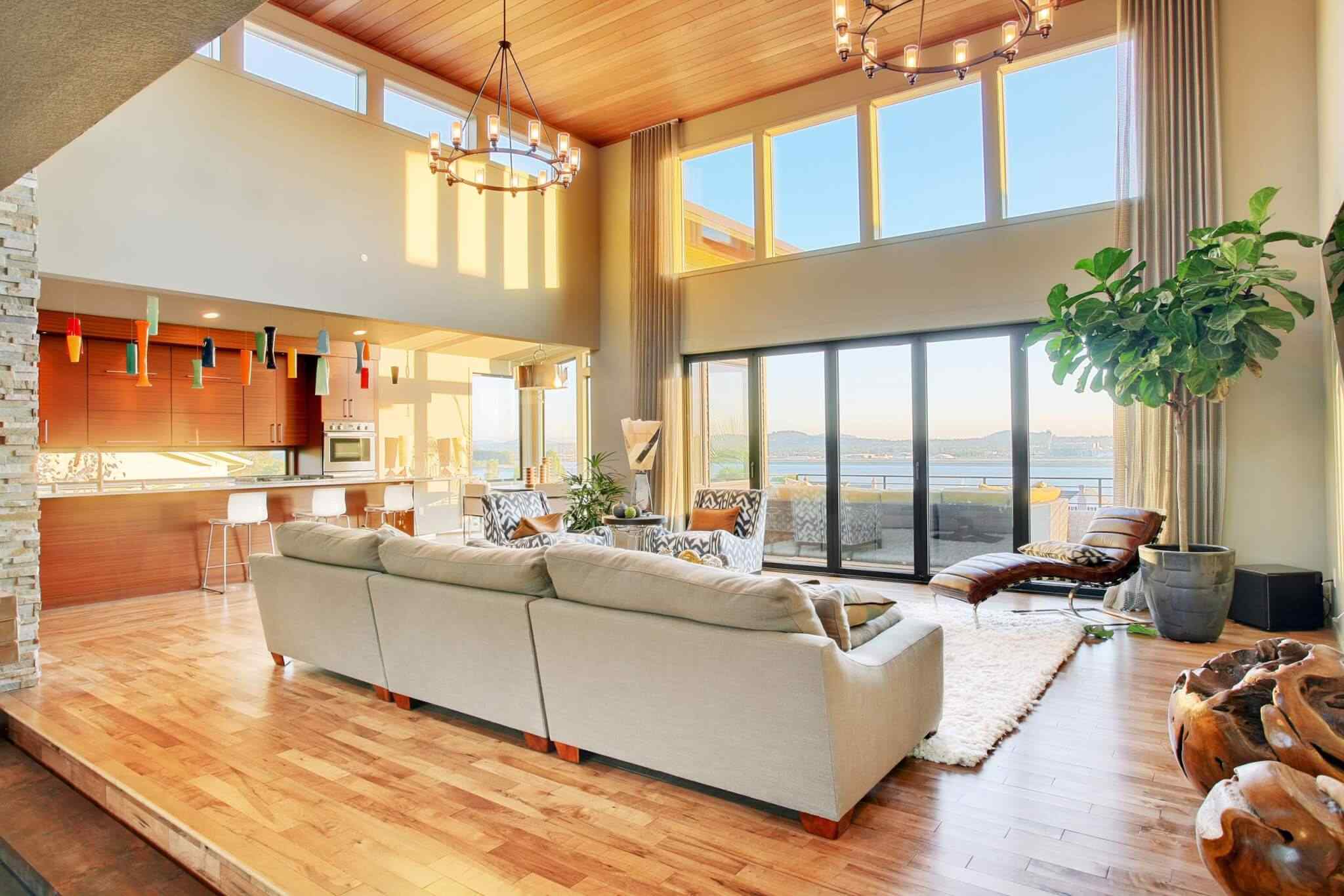 A living room with large windows and wooden floors