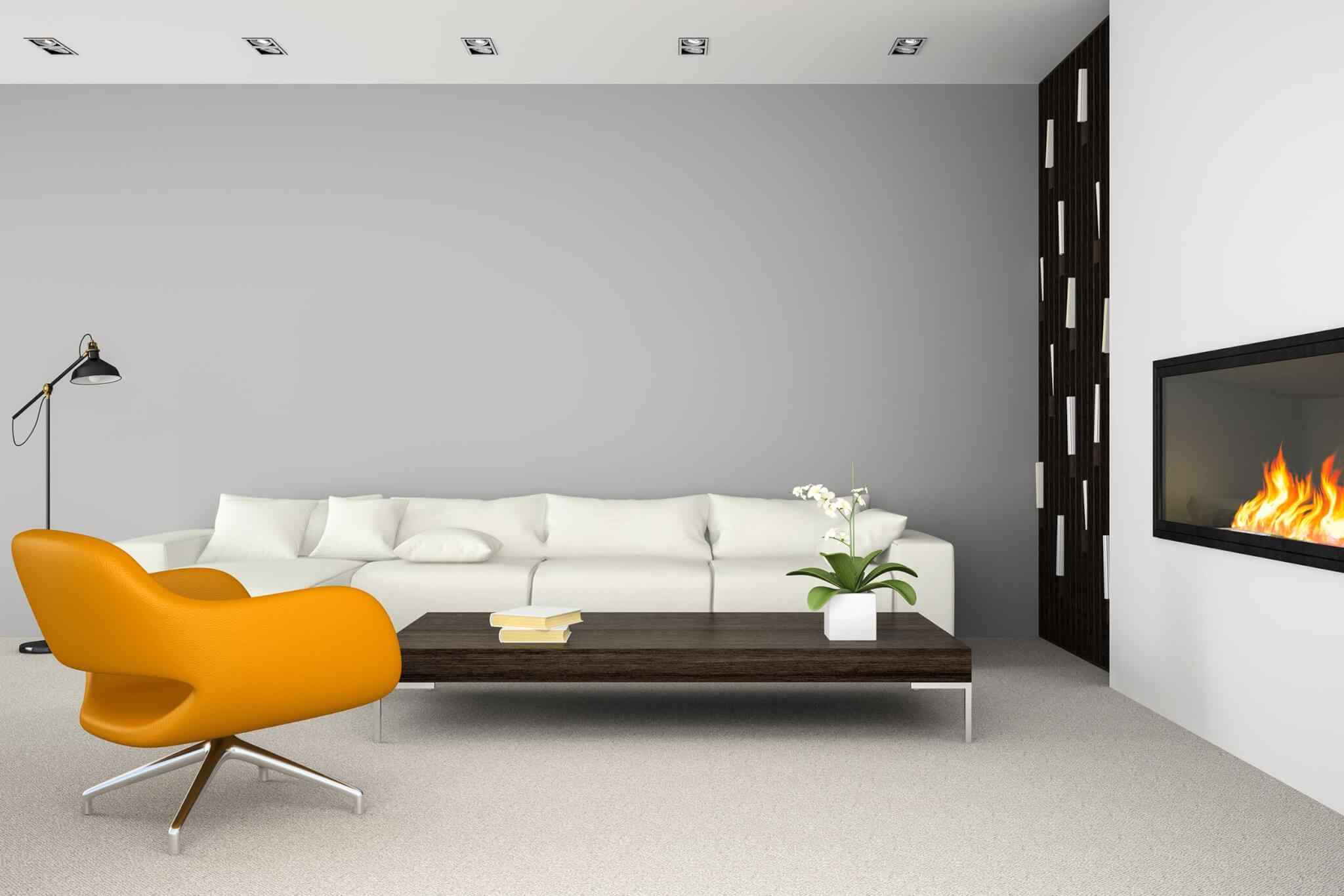 A living room with white furniture and a yellow chair.