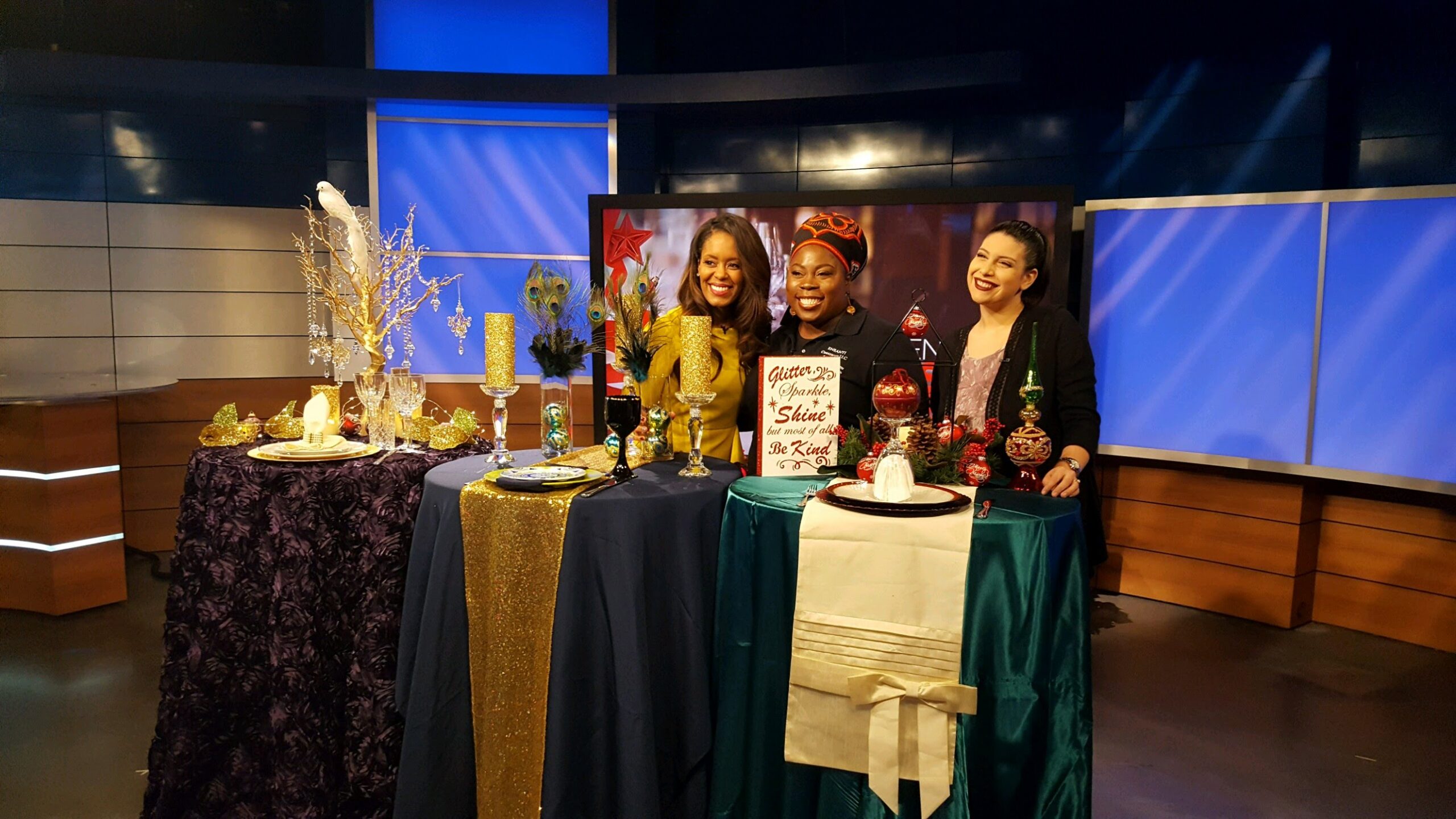 Three women standing at a table with drinks.